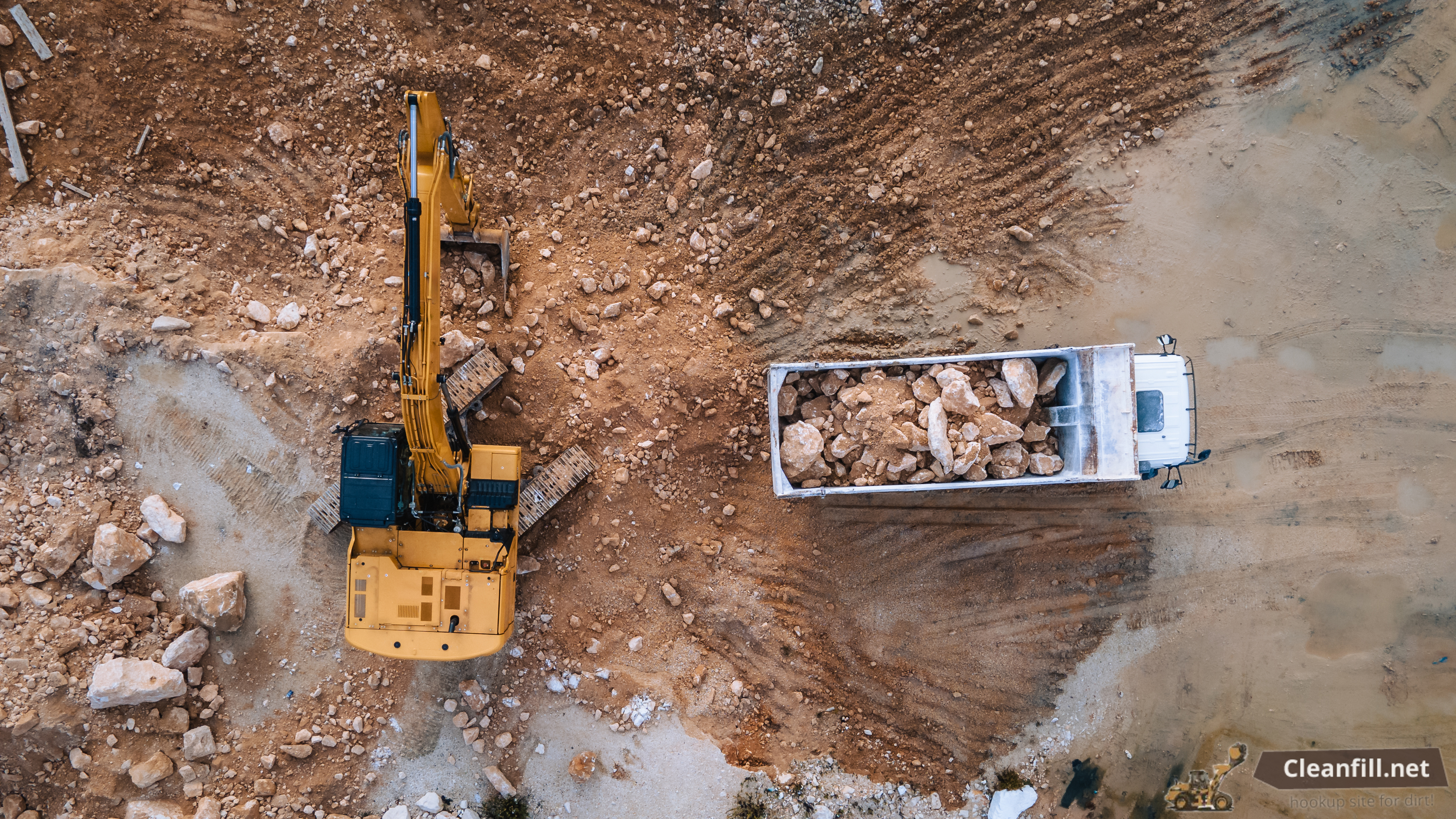 Overhead view of dump truck being loaded with fill material